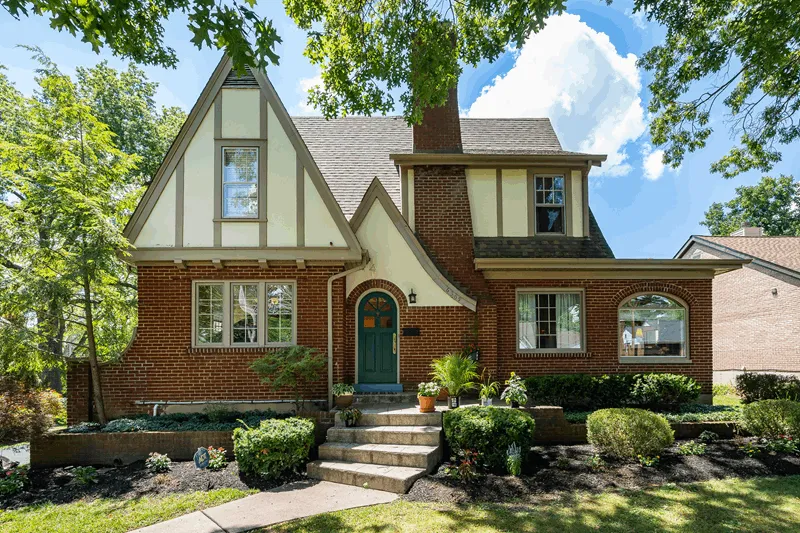 Cincinnati Tudor brick home surrounded by mature trees